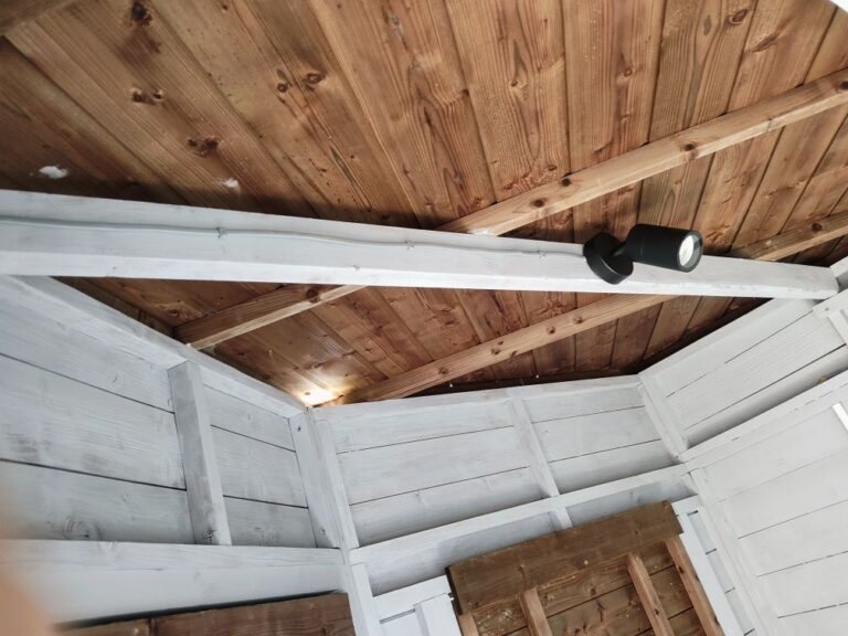 Spotlight fitted to the beam of a garden bar