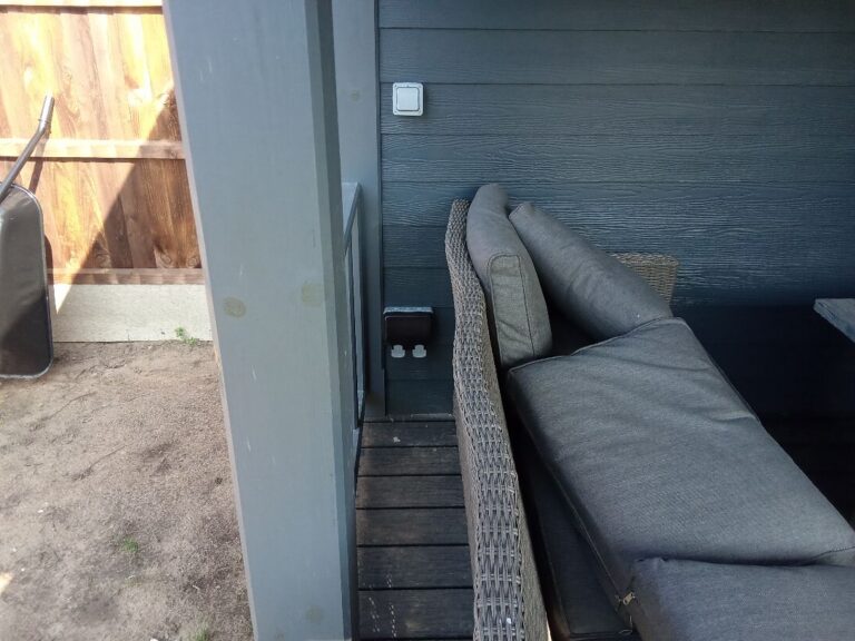 Weatherproof external socket on the side of a garden room